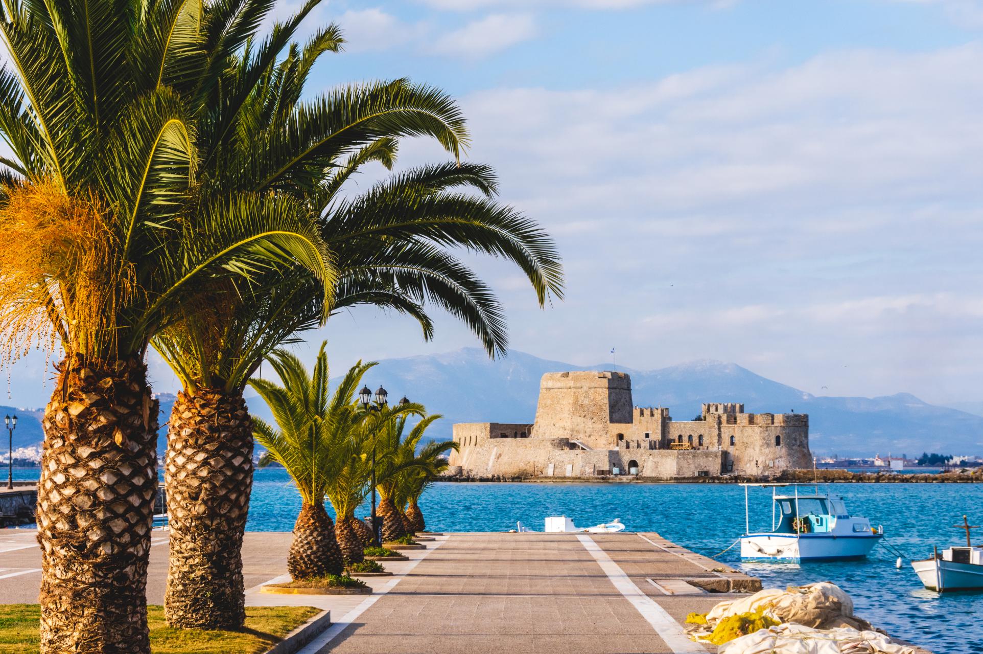 Bourtzi Castle in Nafplio harbor with palm trees Peloponnese Greece