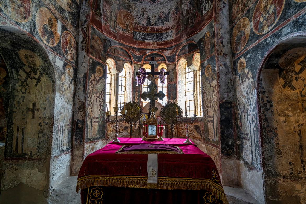 Interior of a Byzantine church with frescoes and altar in Mystras, Greece