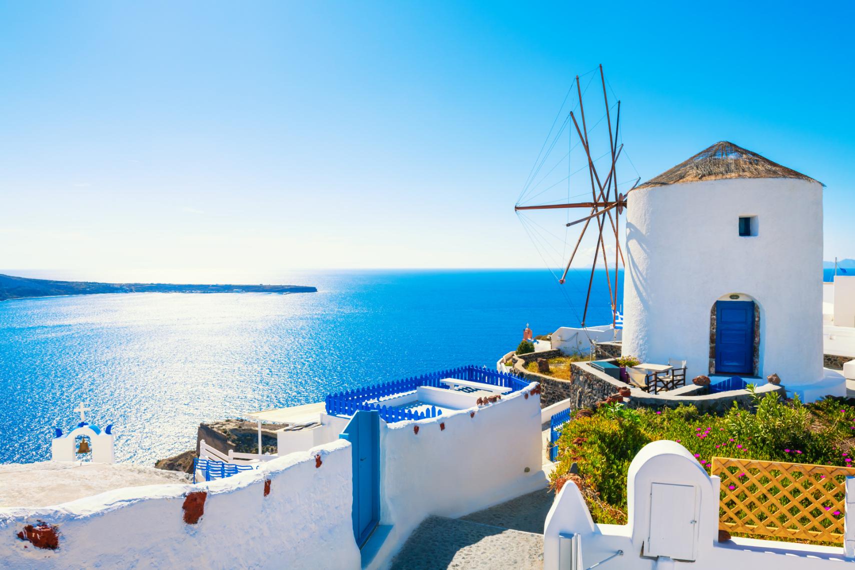 Traditional white windmill overlooking the Aegean Sea in the Cyclades, Greece