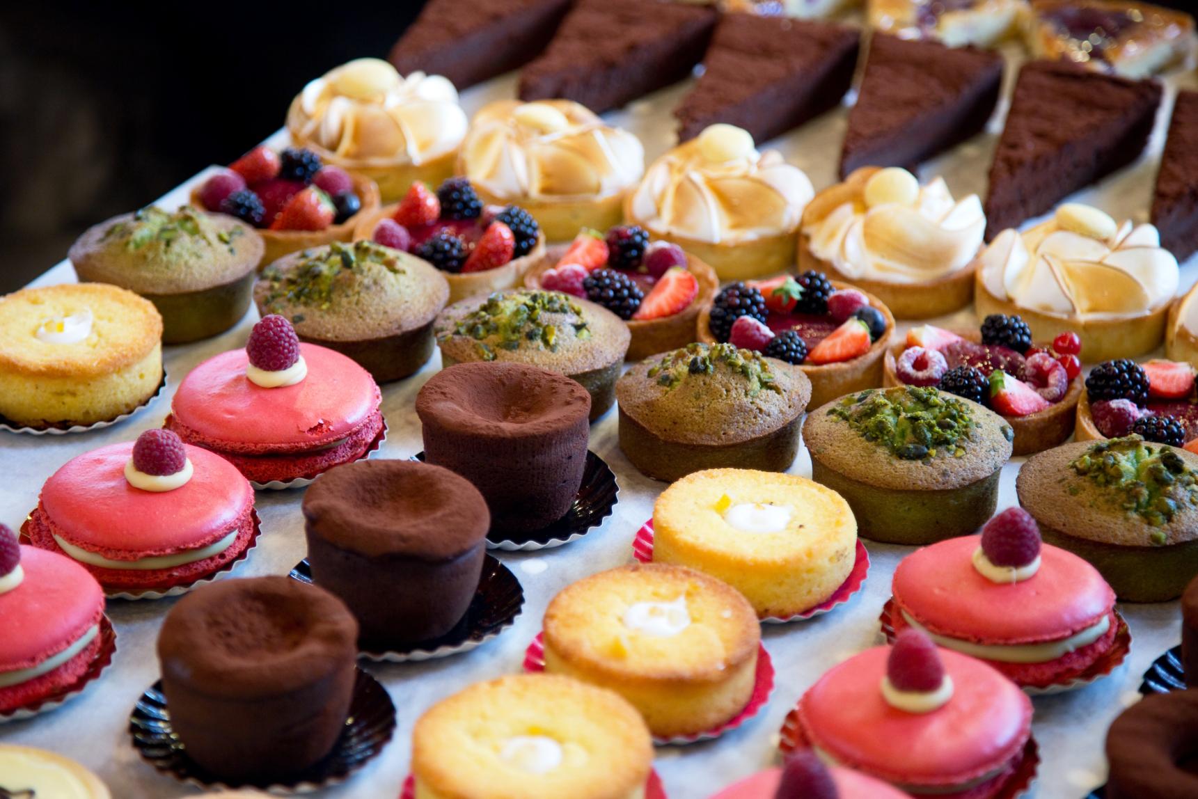 Assorted gourmet desserts and pastries including macarons tarts and cakes