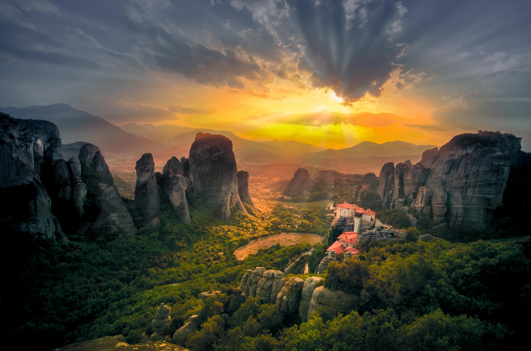 Meteora monasteries on dramatic rock formations at sunset, Thessaly Greece