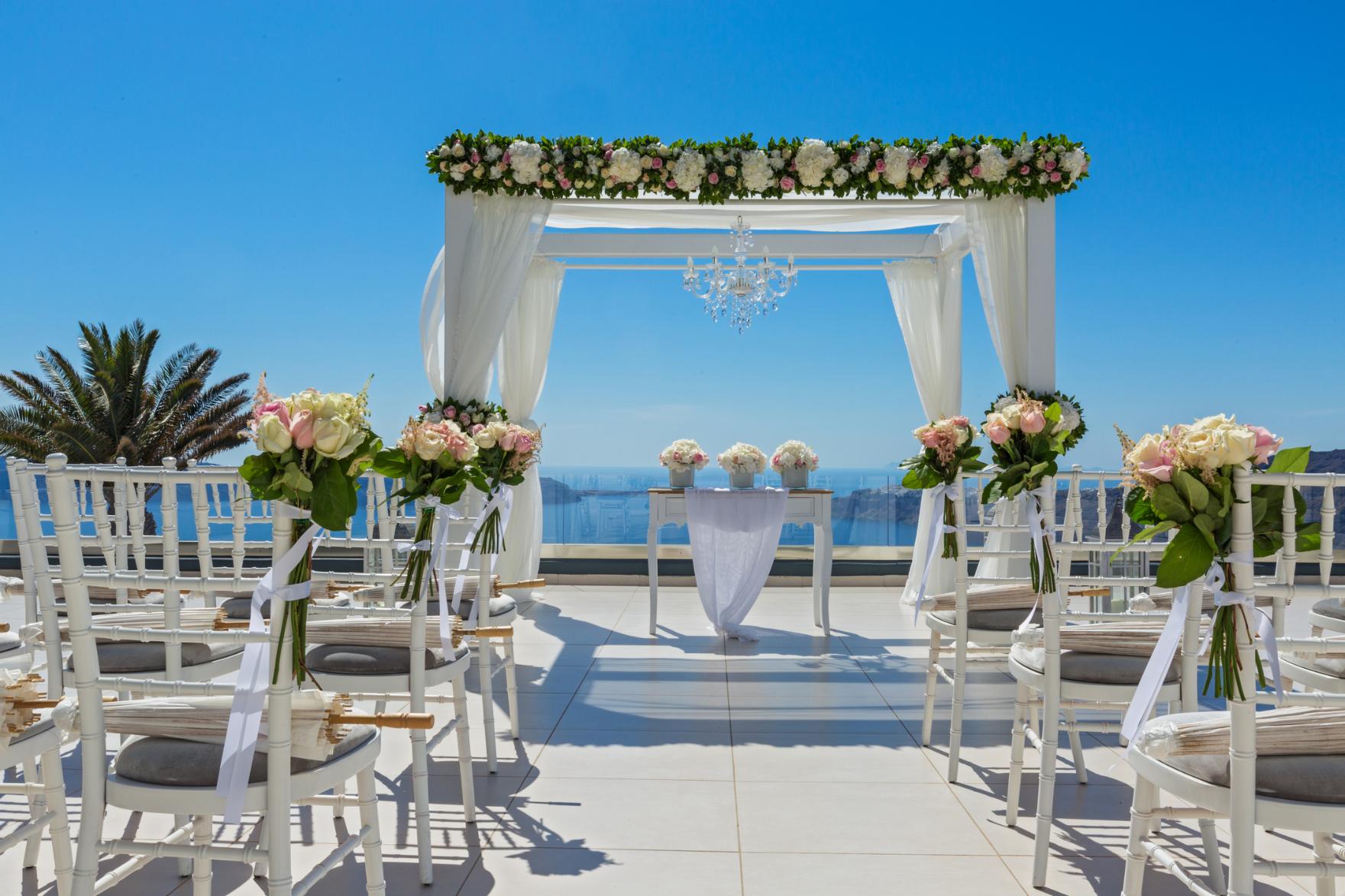 Luxury wedding ceremony setup overlooking the caldera in Santorini Greece